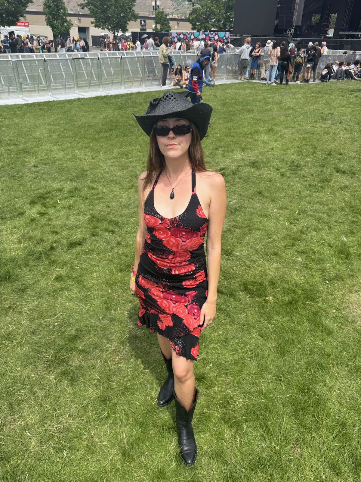 Buffalo Exchange employee Abby outside on a patch of grass wearing a hat