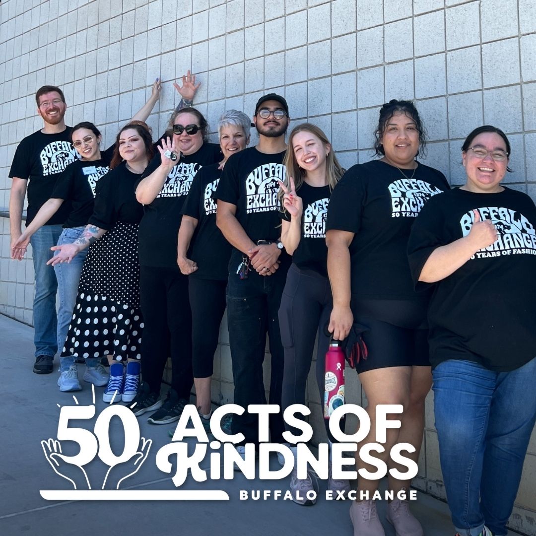 Buffalo Exchange Tucson HQ employees in matching black tees standing outside the Community Food Bank of Southern AZ with text '50 Acts of Kindness' held by illustrated hands at bottom