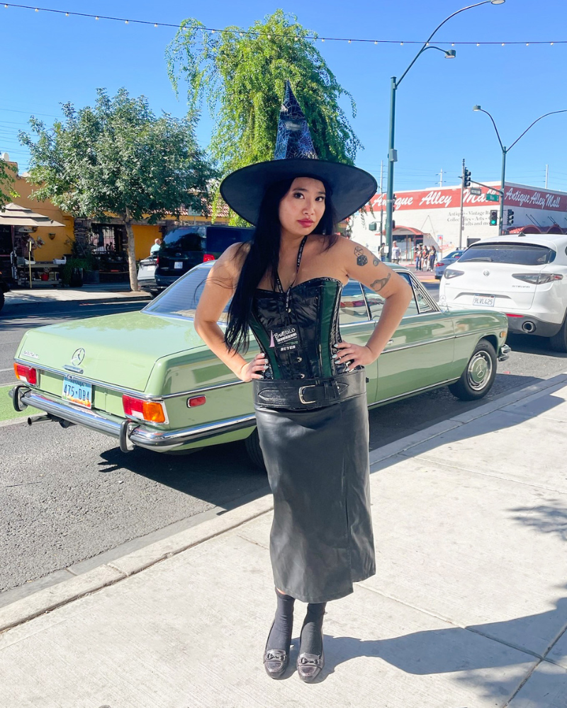 Buffalo Employee in witch hat with leather corset and skirt