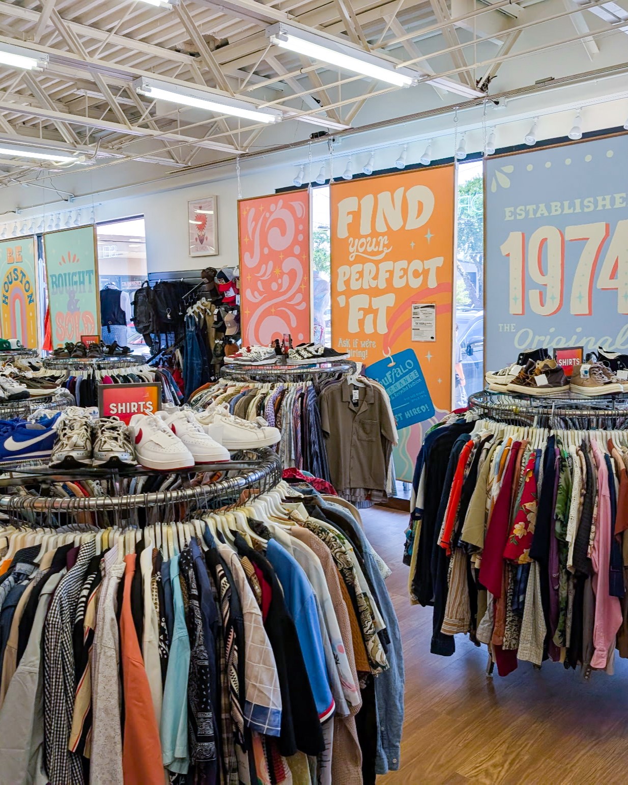 Houston store interior with featuring clothing racks and window signage